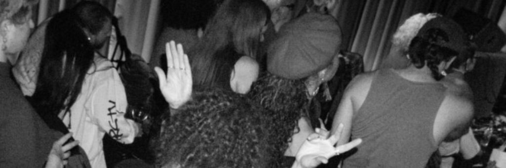 three people shown, the dominant colour of the image is grey
