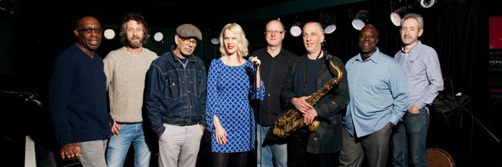 Six quintet or small group shown, with a suitcase, in a group setting