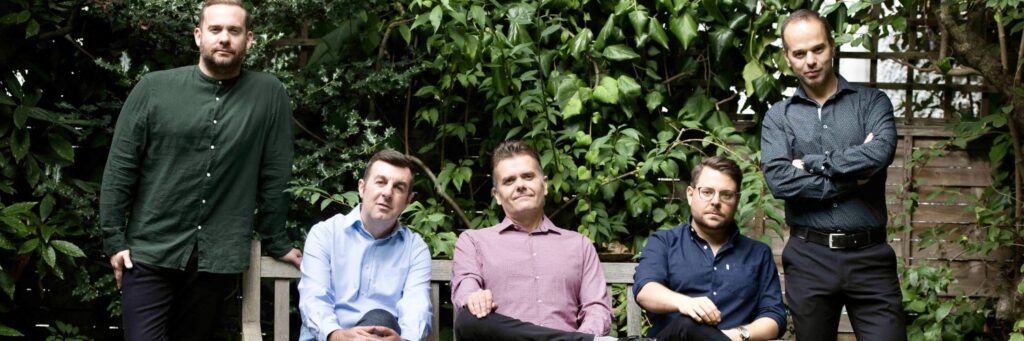 Five quintet or small group shown, outdoors, with a bench, in a group setting